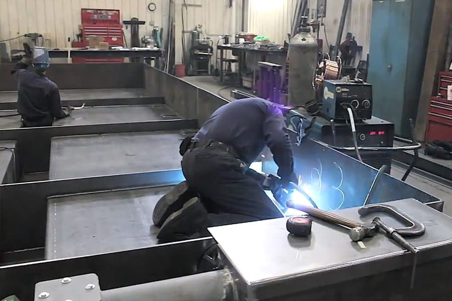 Welder-fabricating and welding on a piece of structural steel