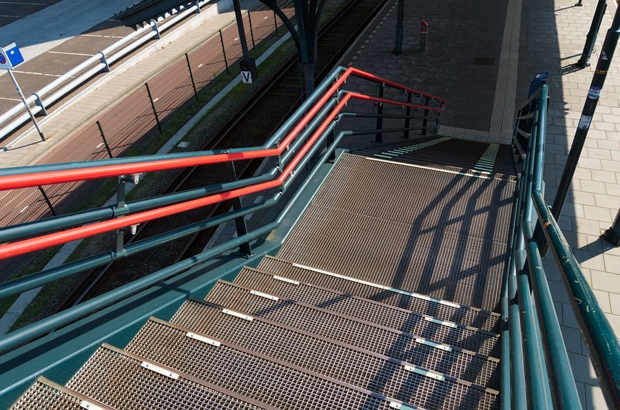metal stairs leading down to a train platform