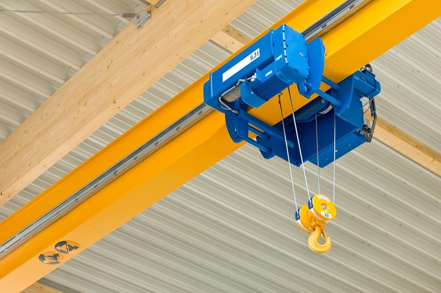 A blue overhead travveling crane in a construction hall