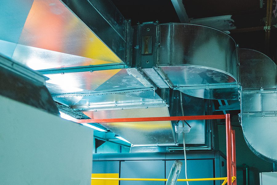 Large industrial ductwork in a factory setting.