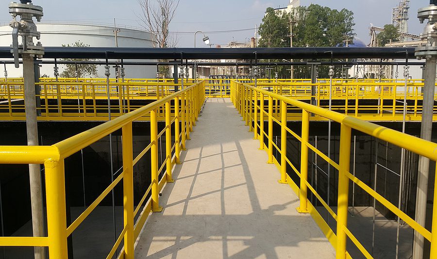 Miles of bright yellow coated industrial exterior steel safety handrail