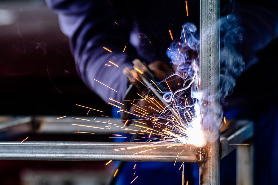 A professional welder working in Swanton Welding, a steel fabrication shop in Toledo, Ohio