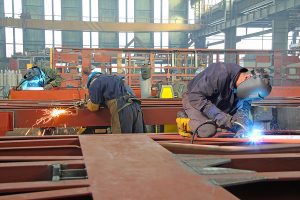 Steel workers welding ,grinding,cutting in metal industry