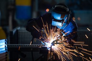 Welder working on a project with sparks flying. 