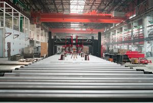 Metal conveyor system with metal rollers in an industrial warehouse setting. 