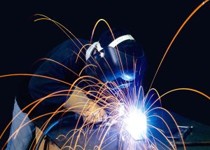 Welder working on a project with sparks flying