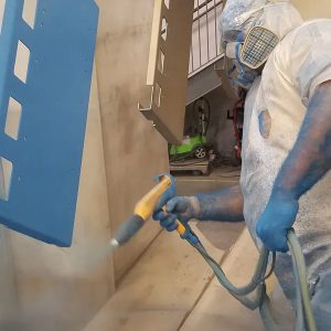 Welder painting a steel project 